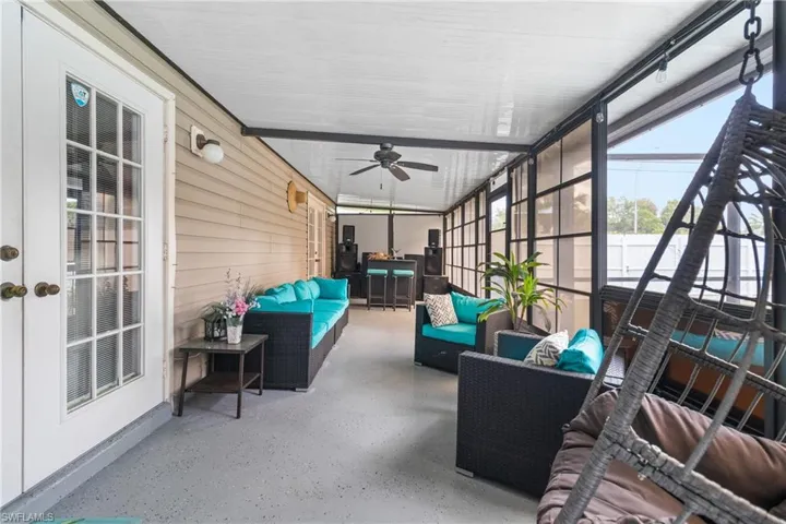 Sunroom featuring outdoor seating and ceiling fan