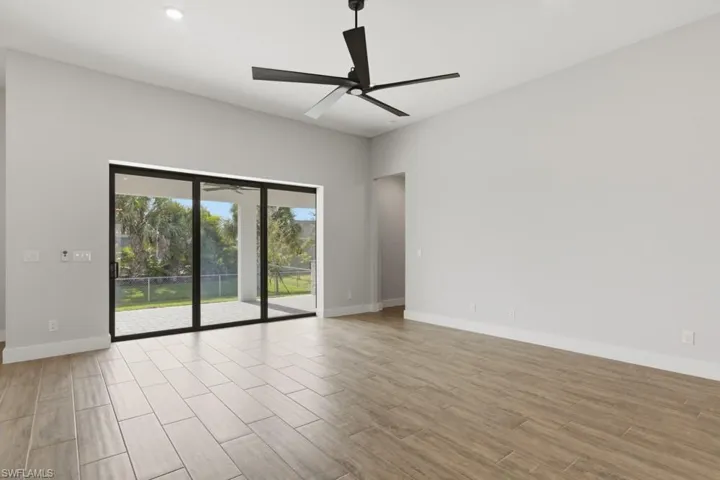living room with luxury tile flooring, ceiling fan, and recessed lighting