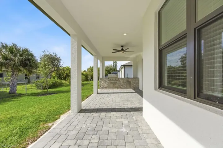 View of patio featuring exterior kitchen and a ceiling fan