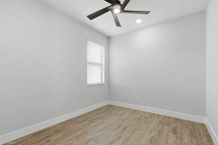 Spare room featuring light wood-style floors and ceiling fan