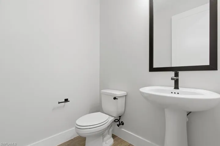 Bathroom with baseboards and wood finished floors