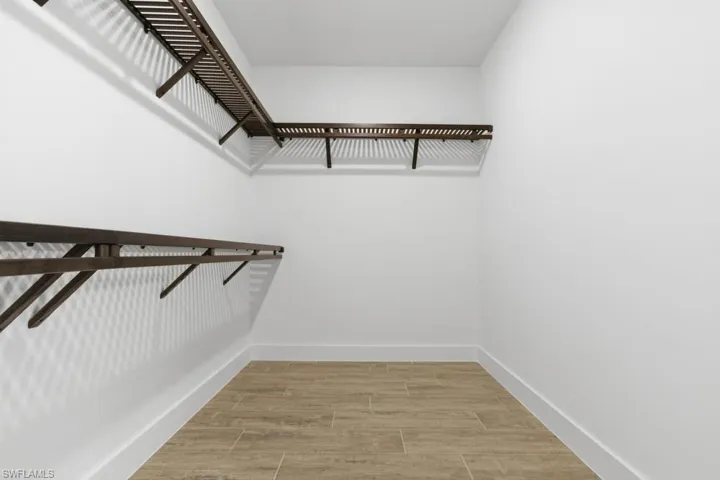Master bedroom closet with luxury tile flooring
