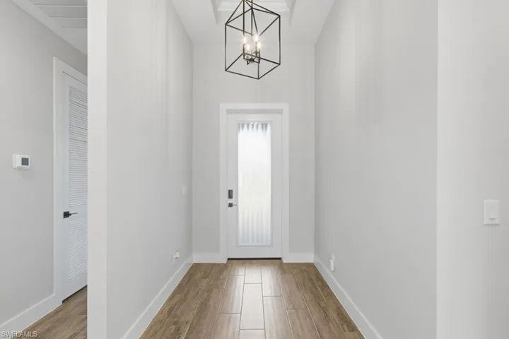 Entryway featuring luxury tile flooring, and chandelier