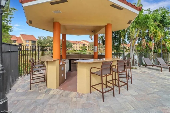 View of patio featuring outdoor dry bar and fence