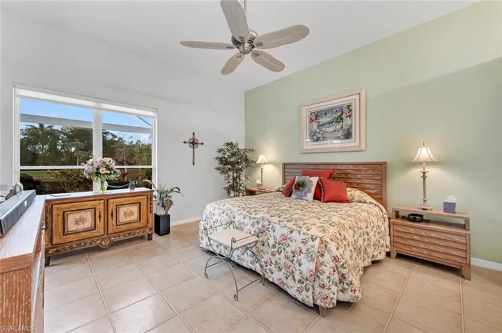 Bedroom featuring light tile patterned floors and ceiling fan