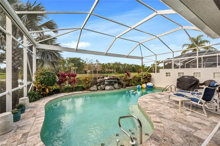 View of swimming pool with grilling area, a lanai, and a patio area