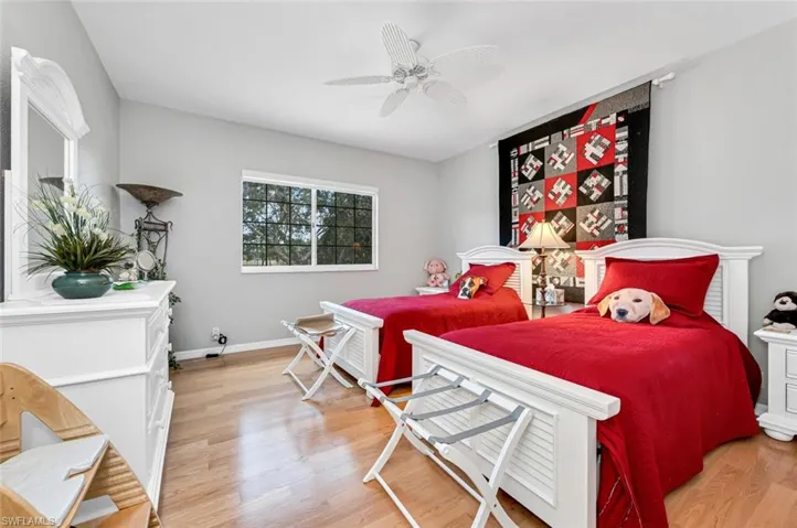 Bedroom with light hardwood / wood-style floors and ceiling fan