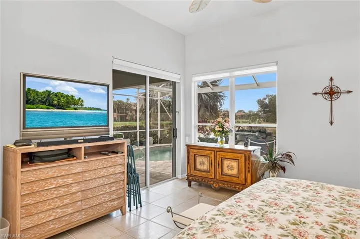 Bedroom featuring light tile patterned floors, access to outside, and ceiling fan