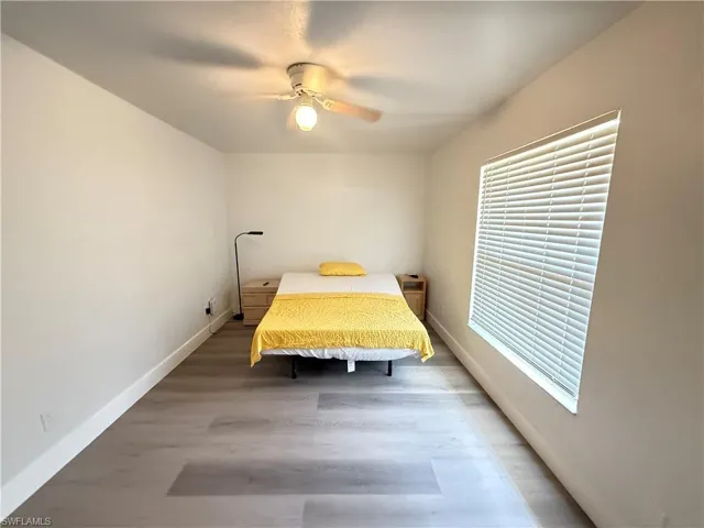 Bedroom with light laminate flooring and ceiling fan