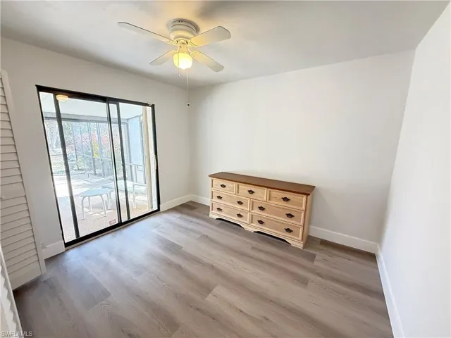Unfurnished room featuring light laminate flooring and a ceiling fan