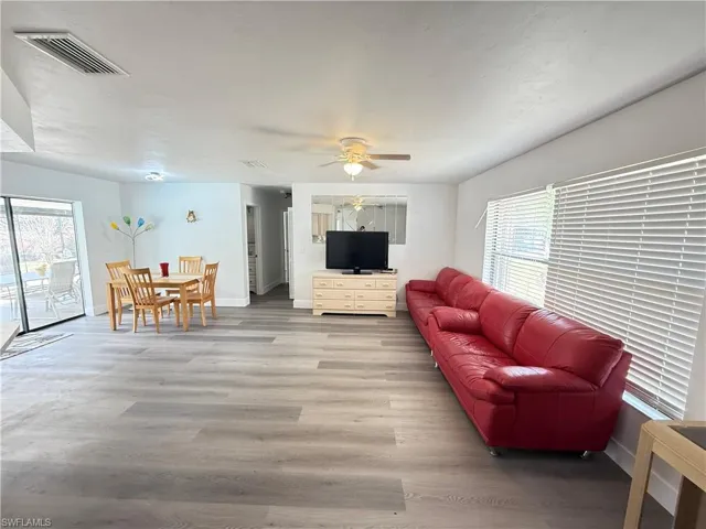 Living room featuring ceiling fan and light laminate floors