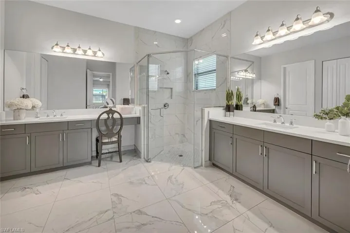 Master Bathroom room with duel sinks and a walk in shower