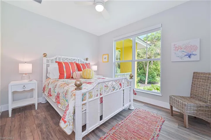 Bedroom featuring wood-finish flooring and a large window