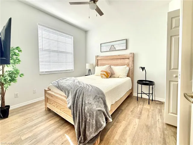 Bedroom with light wood-style floors and a ceiling fan
