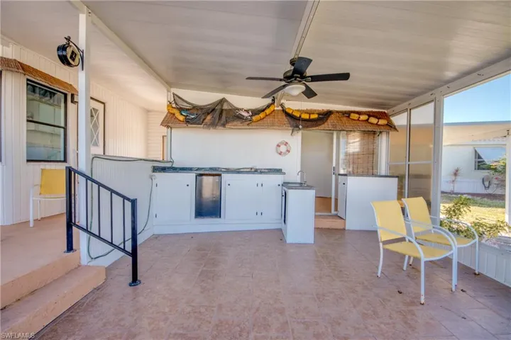 View of patio / terrace with ceiling fan, outdoor kitchen area for grilling, and a sunroom