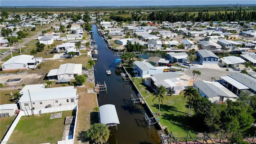 Aerial view of property's location with nearby suburban area and a nearby body of water