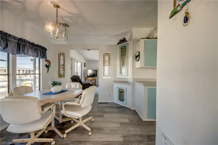 Dining area featuring wood finished floors and a chandelier