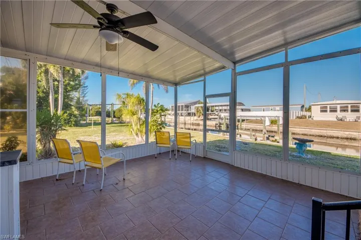 Unfurnished sunroom with a ceiling fan