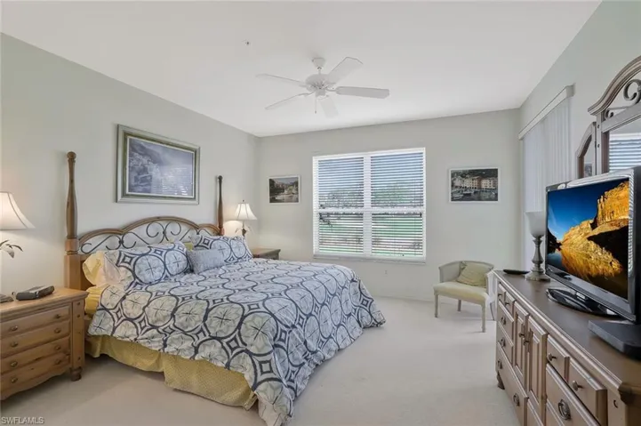 Bedroom featuring light colored carpet and ceiling fan
