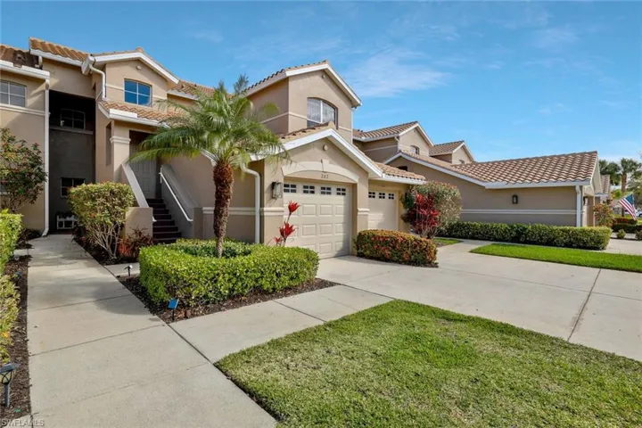 Mediterranean / spanish-style house with stucco siding, a garage, concrete driveway, a tiled roof, and a front yard