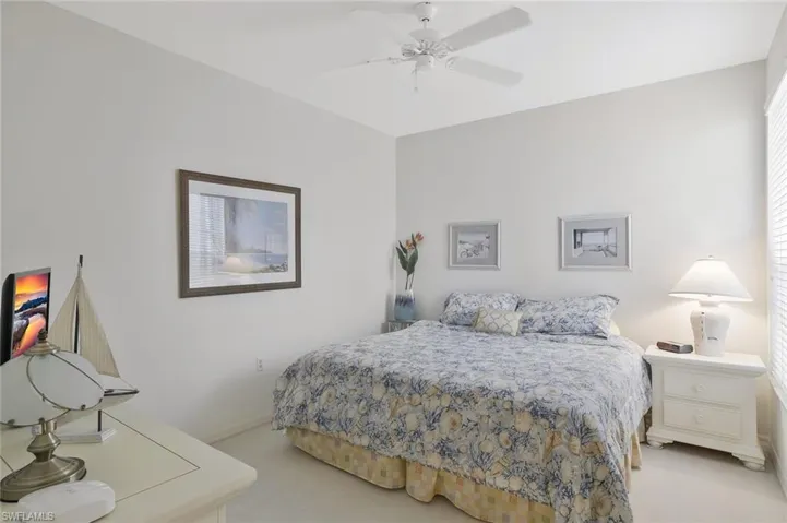 Bedroom with light colored carpet and ceiling fan