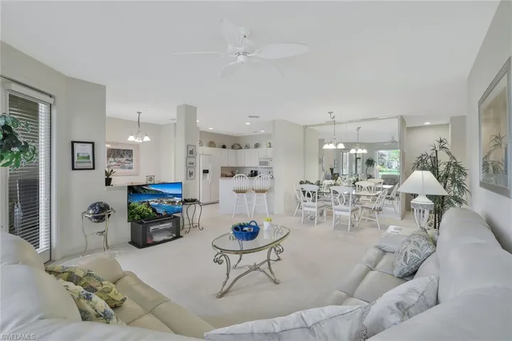 Living room with suspended lighting and ceiling fan