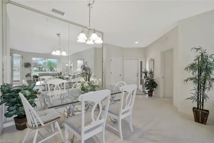 Dining room featuring hanging lights and light carpet