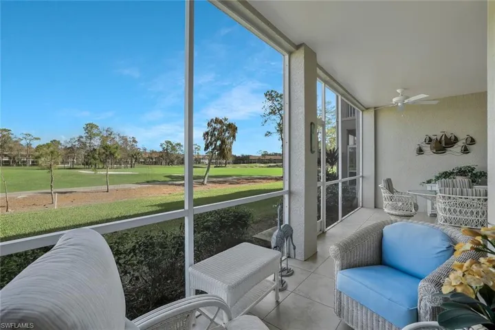 Sunroom / solarium with a ceiling fan and view of golf course