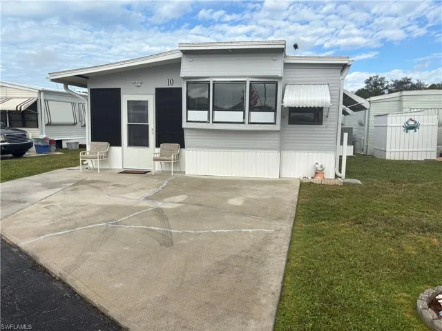 FRONT of property with a yard