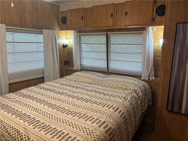Bedroom with wood walls