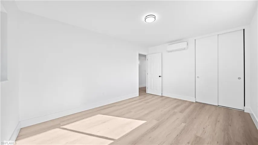 Unfurnished bedroom featuring a closet and light wood-type flooring