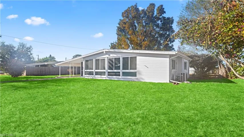 Rear view of house with a sunroom