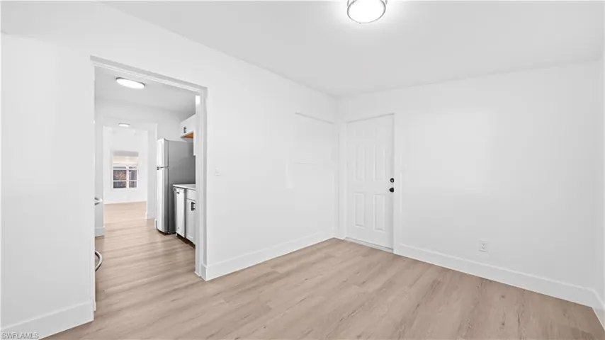Unfurnished room featuring baseboards and light wood-type flooring