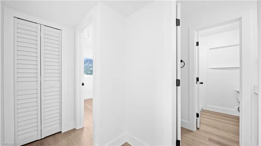 Hallway with light wood finished floors