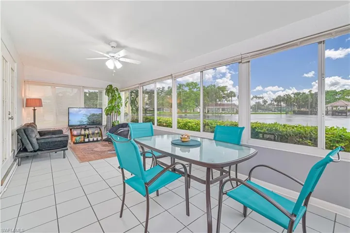 Sunroom featuring tile patterned flooring and baseboards
