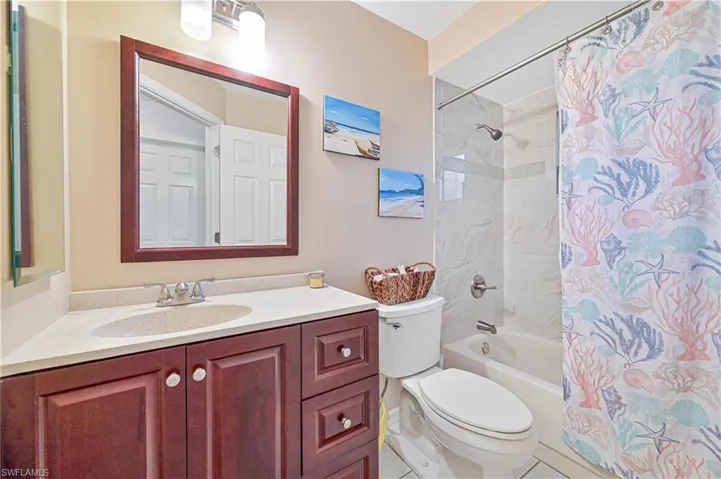 Full bath with vanity and shower / bath combination with curtain