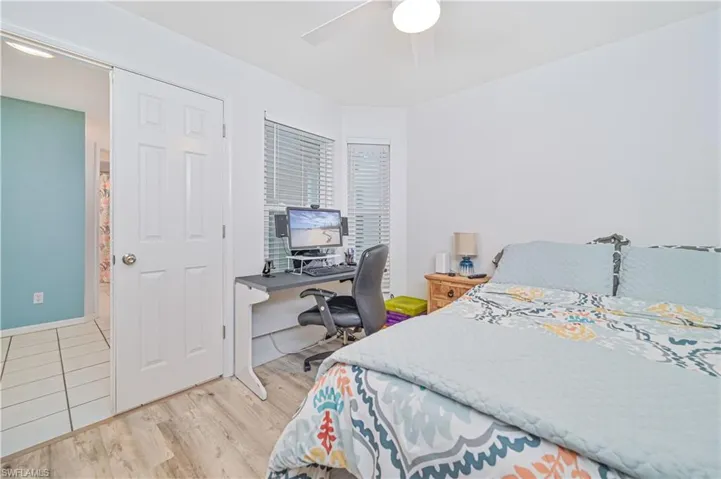 Bedroom featuring a desk, a ceiling fan, and light wood-type flooring