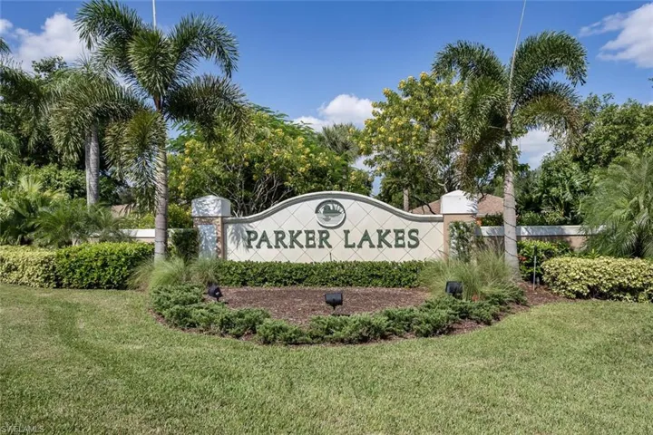 Community / neighborhood sign featuring a yard