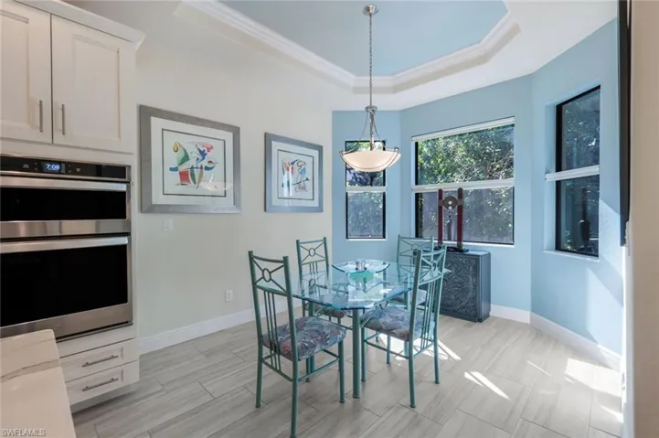 Dining area with ornamental molding and a tray ceiling