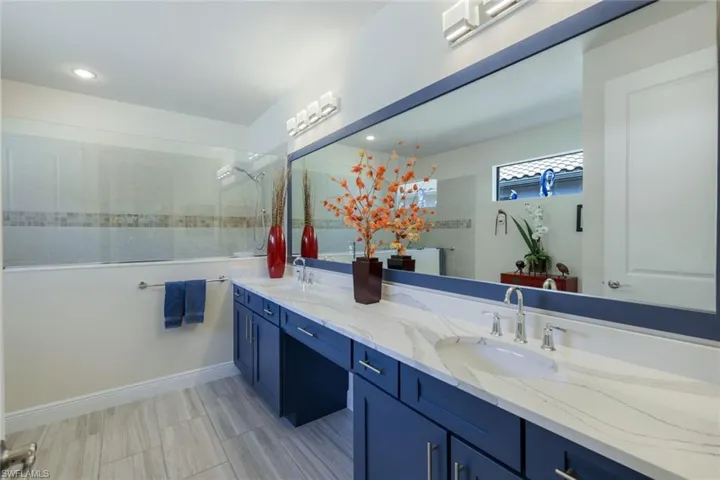 Bathroom with a tile shower and vanity