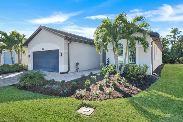 View of front facade with a garage and a front yard