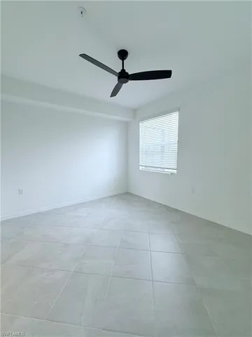 Empty room with baseboards and ceiling fan