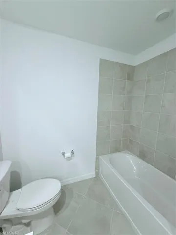 Full bathroom with a garden tub and tile patterned floors