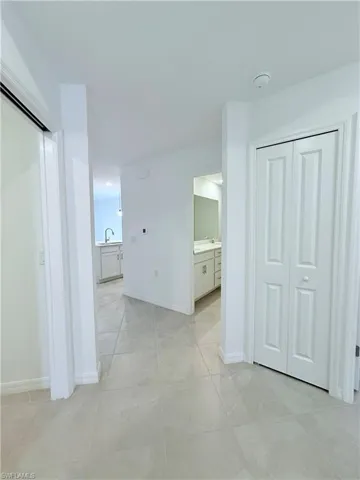 Hall with baseboards and a sink