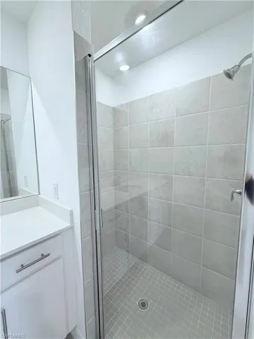 Bathroom with a stall shower and vanity