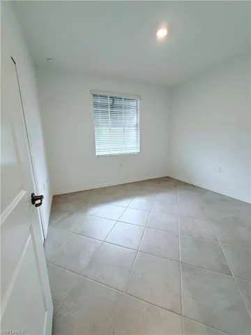 Unfurnished room with light tile patterned flooring and recessed lighting