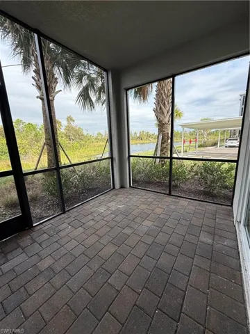 Unfurnished sunroom with a water view