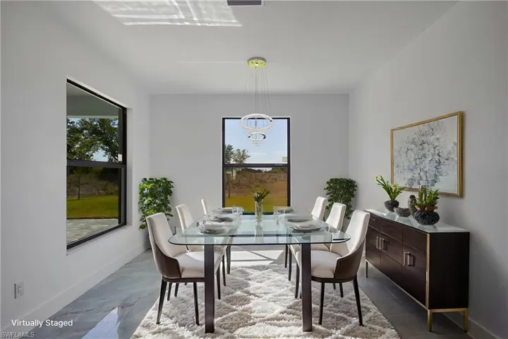 Dining room featuring baseboards and a chandelier