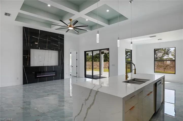 Kitchen with visible vents, open floor plan, modern cabinets, and a sink