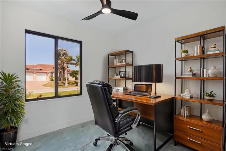 Office with baseboards, a ceiling fan, and marble finish floor